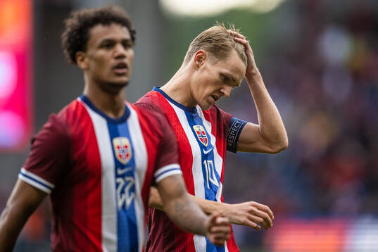 Oscar Bobb and Martin Ødegaard look dejected