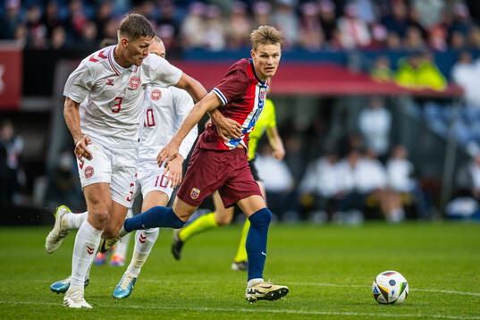 Jannik Vestergaard of Denmark and Martin Ødegaard of Norway