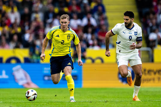 Emil Krafth of Sweden and Aleksandar Mitrovic of Serbia