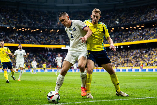 Nikola Milenkovic of Serbia and Dejan Kulusevski of Sweden