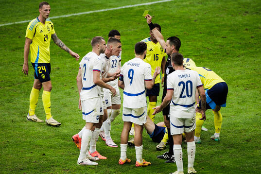Strahinja Pavlovic of Serbia receives a yellow card