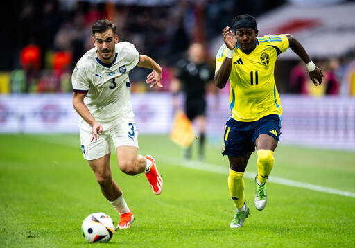 Nemanja Stojic of Serbia and Anthony Elanga of Sweden