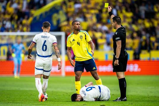 Isak Hien of Sweden receives a yellow card