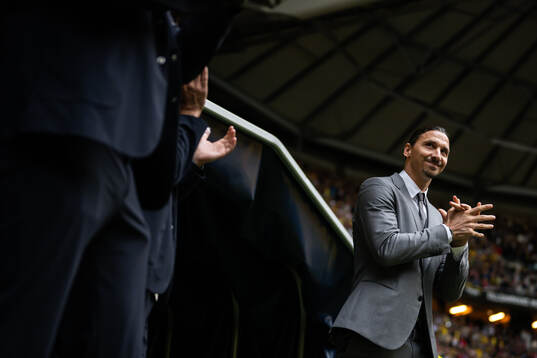 Zlatan Ibrahimovic enter the pitch to a ceremony to honor