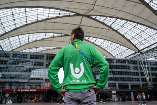 A volunteer is seen at Munich Airport