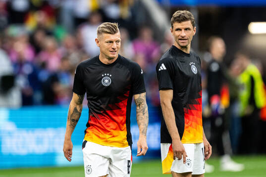 Toni Kroos and Thomas Müller of Germany
