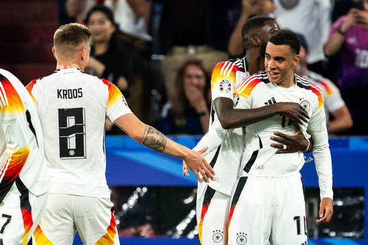 Jamal Musiala of Germany celebrates with Antonio Rüdiger