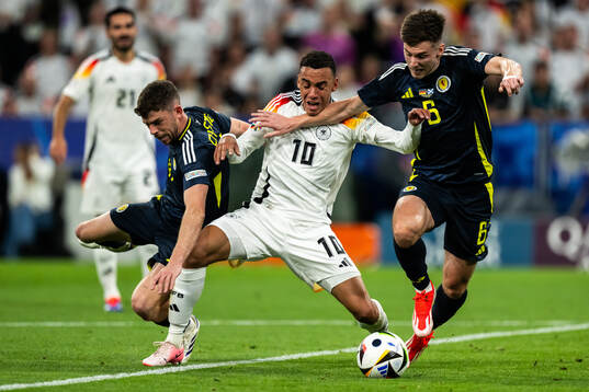 Ryan Christie and Kieran Tierney of Scotland against Jamal