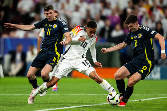 Ryan Christie and Kieran Tierney of Scotland against Jamal