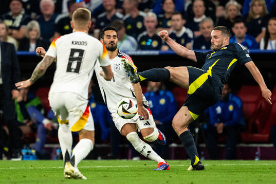 Ilkay Gündogan of Germany and John McGinn of Scotland