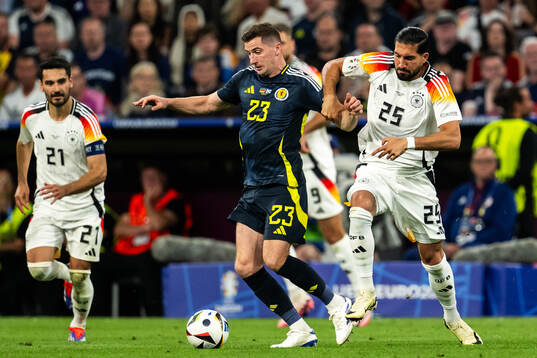 Kenny McLean of Scotland and Emre Can of Germany