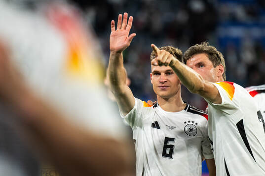 Joshua Kimmich and Thomas Müller of Germany celebrate