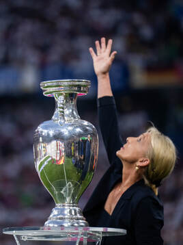 Heidi Beckenbauer is seen pointing to the sky with the