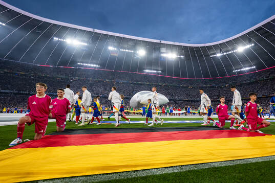 Toni Kroos and Jamal Musiala of Germany enter the pitch