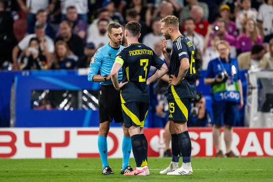 Referee Clément Turpin talks to Andrew Robertson and Ryan
