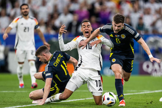 Ryan Christie and Kieran Tierney of Scotland compete for