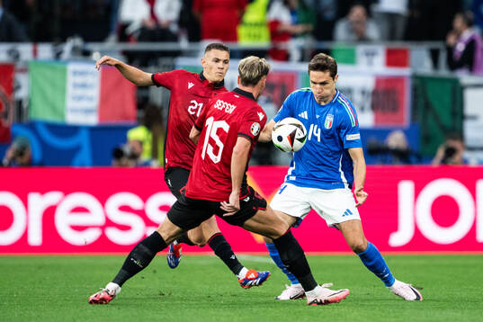 Kristjan Asllani of Albania and Federico Chiesa of Italy