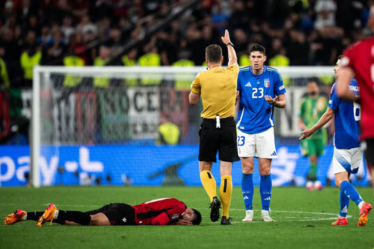 Alessandro Bastoni of Italy reacts towards referee Felix