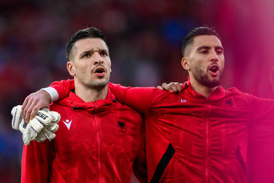 Medon Berisha and goalkeeper Thomas Strakosha of Albania