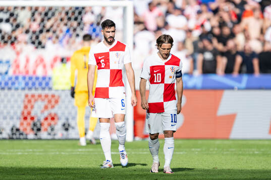 Josip Sutalo and Luka Modric of Croatia look dejected