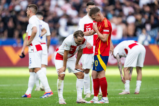 Daniel Olmo of Spain consoles Lovro Majer of Croatia