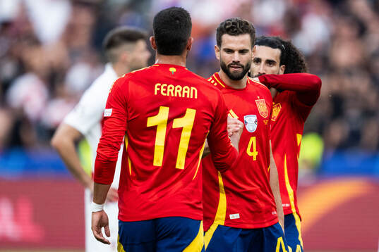 Ferran Torres and Nacho of Spain celebrate