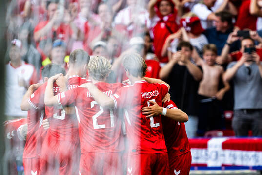 Christian Eriksen of Denmark celebrates with team mates