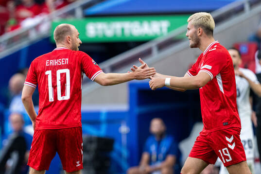 Christian Eriksen of Denmark celebrates with Jonas Wind