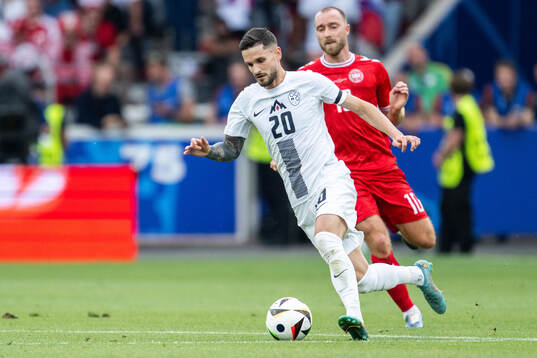 Petar Stojanovic of Slovenia and Christian Eriksen of