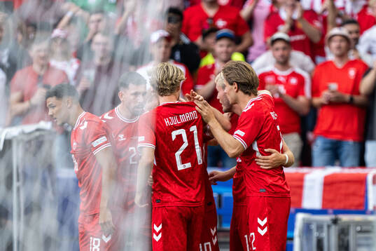 Christian Eriksen of Denmark celebrates with team mates