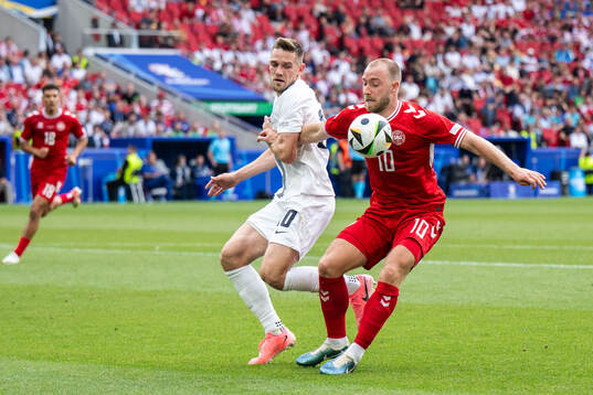 Timi Elsnik of Slovenia and Christian Eriksen of Denmark
