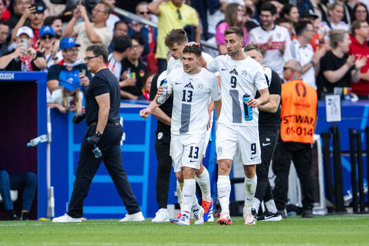 Erik Janza of Slovenia celebrates with Andraz Sporar