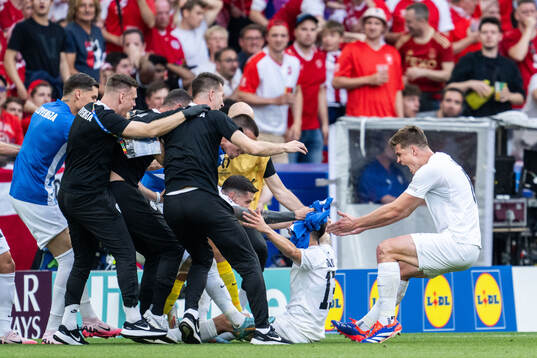 Erik Janza of Slovenia celebrates with team mates