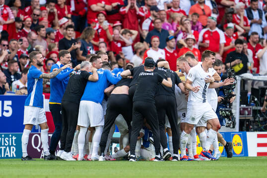 Erik Janza of Slovenia celebrates with team mates