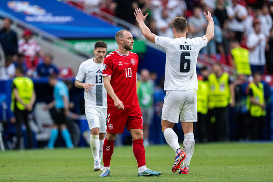 Christian Eriksen of Denmark looks dejected while Erik