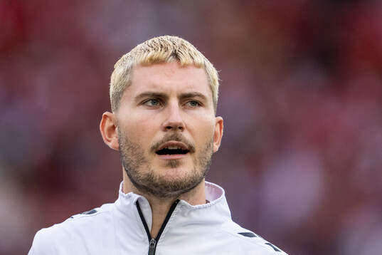 Jonas Wind of Denmark sings the national anthem