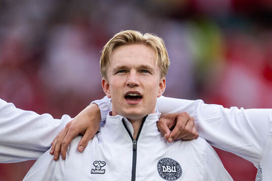 Victor Kristiansen of Denmark sings the national anthem