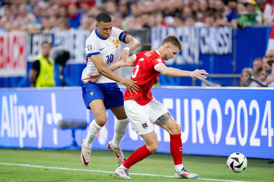 Kylian Mbappé of France and Stefan Posch of Austria