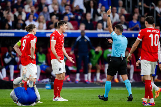 Maximilian Wöber of Austria receives a yellow card