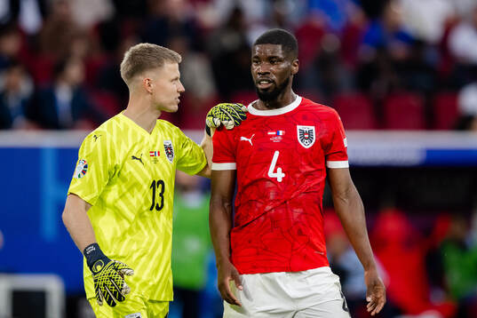 Goalkeeper Patrick Pentz and Kevin Danso of Austria