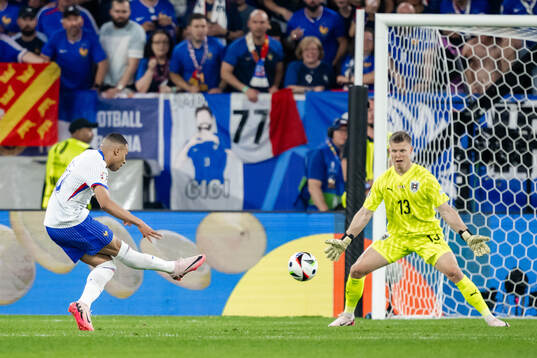 Kylian Mbappé of France against goalkeeper Patrick Pentz