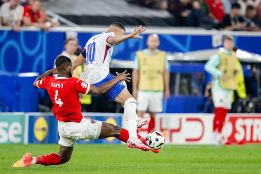 Kevin Danso of Austria and Kylian Mbappé of France
