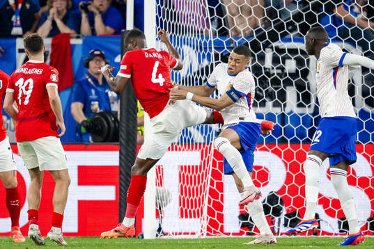 Kevin Danso of Austria and Kylian Mbappé of France