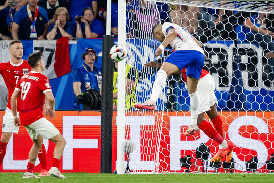 Kevin Danso of Austria and Kylian Mbappé of France
