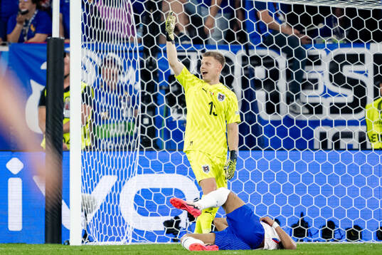 Goalkeeper Patrick Pentz of Austria and Kylian Mbappé of
