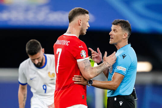 Marko Arnautovic of Austria and referee Jesus Gil Manzano