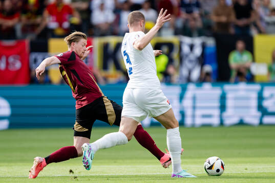 Kevin De Bruyne of Belgium and Denis Vavro of Slovakia