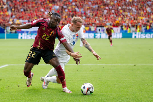 Jeremy Doku of Belgium and Ondrej Duda of Slovakia
