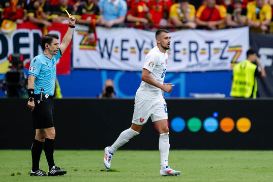 Ivan Schranz of Slovakia receives a yellow card