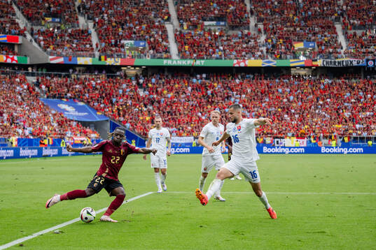 Jeremy Doku of Belgium and David Hancko of Slovakia